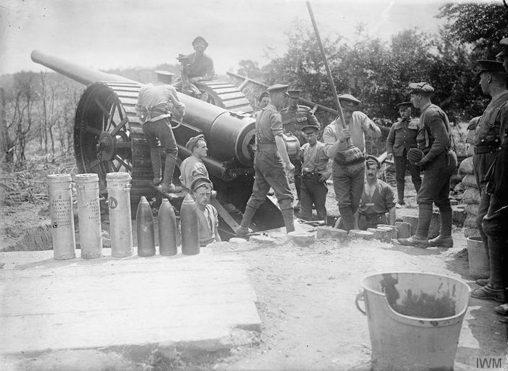 An 8-inch howitzer and its gun crew, with stacked shells